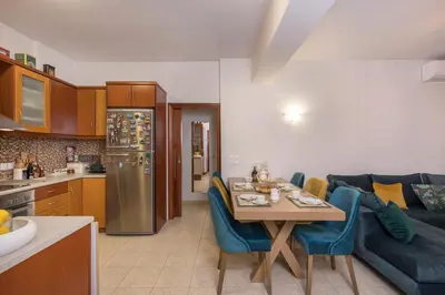 a kitchen and living room with a table and a couch at Urban Oasis Central in Chania Town
