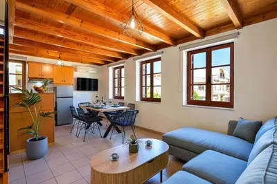 a living room with a couch and a table at Old Town Loft with Sea View Roof Terrace and Private Parking in Chania Town