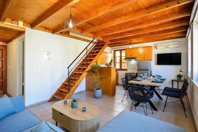 a living room with a blue couch and a table at Old Town Loft with Sea View Roof Terrace and Private Parking in Chania Town