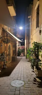 an alley at night with a light on a building at Old Town Loft with Sea View Roof Terrace and Private Parking in Chania Town