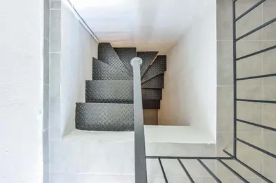 a spiral staircase in a building with a stair case at Old Town Loft with Sea View Roof Terrace and Private Parking in Chania Town