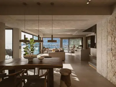 a dining room and living room with a dining table at Villa Albero - Sea View Escape in Souda