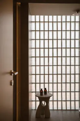 a small table in front of a large window at Villa Albero - Sea View Escape in Souda