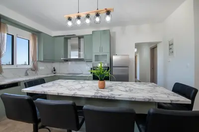a kitchen with a large marble table and chairs at FRDomus in Daratso