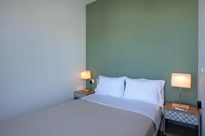 a bedroom with a bed and two lamps on tables at FRDomus in Daratso