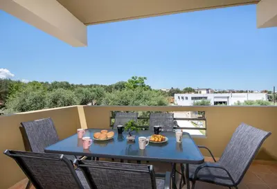 a table with food on a balcony with chairs at FRDomus in Daratso