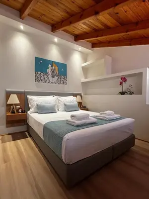 a bedroom with a large bed with a wooden ceiling at Duplex apartment city center in Chania Town