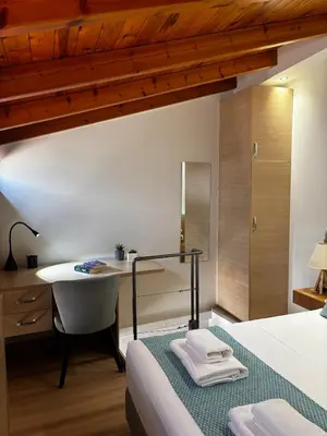 a bedroom with a bed and a desk and a table at Duplex apartment city center in Chania Town