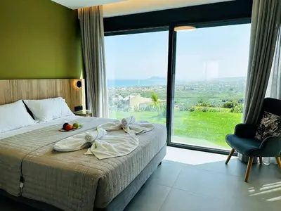 a bedroom with a bed and a large window at Skyline Serenity Villa 10 people 4bedroom 3ba, 3min To Beach in Maleme