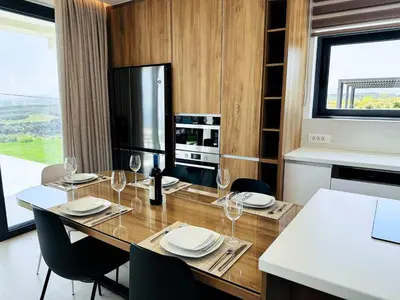 a dining room with a table with wine glasses at Skyline Serenity Villa 10 people 4bedroom 3ba, 3min To Beach in Maleme