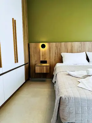 a bedroom with a bed and a green wall at Skyline Serenity Villa 10 people 4bedroom 3ba, 3min To Beach in Maleme
