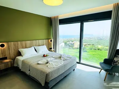 a bedroom with a bed and a large window at Skyline Serenity Villa 10 people 4bedroom 3ba, 3min To Beach in Maleme