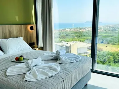 a bedroom with a bed with towels and fruit on it at Skyline Serenity Villa 10 people 4bedroom 3ba, 3min To Beach in Maleme