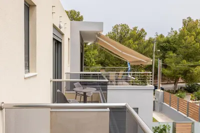 a balcony of a house with a table and chairs at Park and sea view Villa with Private Pool 2 in Chania Town