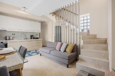 a living room with a couch and a kitchen at Park and sea view Villa with Private Pool 2 in Chania Town