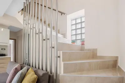 a staircase in a home with white walls and wooden floors at Park and sea view Villa with Private Pool 2 in Chania Town