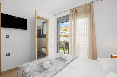a bedroom with a bed with towels on it at Park and sea view Villa with Private Pool 2 in Chania Town