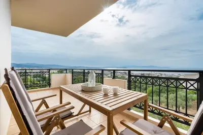 a table and chairs on a balcony with a view at Aelia Sea View in Chania Town