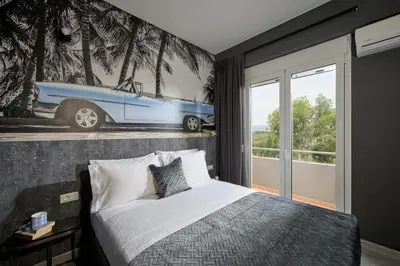 a bedroom with a bed and a car on the wall at Mons Villa in Kalathas