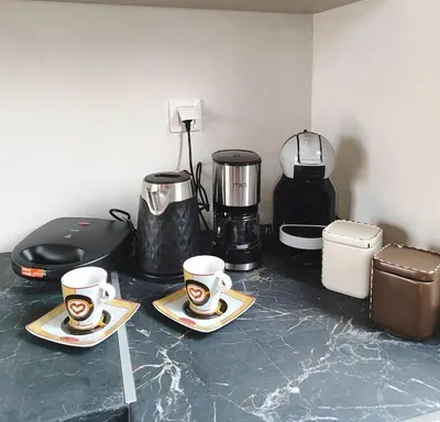 a counter with two cups and a coffee maker at Coastal Haven Your Oasis by the Sea in Análipsis