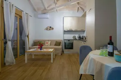 a small living room with a table and a couch at Coastal Haven Your Oasis by the Sea in Análipsis
