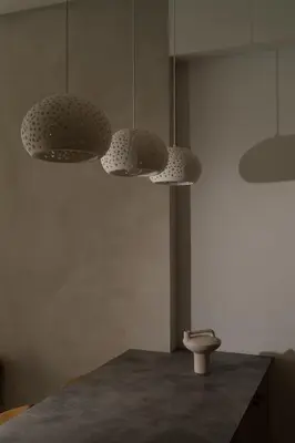 a kitchen with three lights and a table at Athos Guesthouse in Stalos