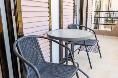 two chairs and a table on a patio at Sun Beach Apartment in Chania 3 in Chania Town