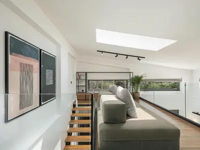 a living room with a couch and stairs at P Project Houses in Aghii Apostoli