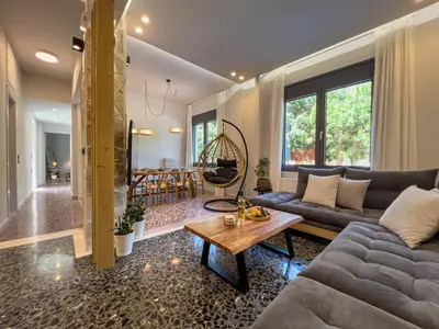 a living room with a couch and a table at Apẽron Suite - Downtown Chania in Chania Town