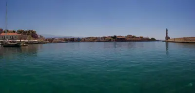 a large body of water with a city in the background at Apẽron Suite - Downtown Chania in Chania Town