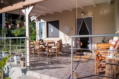 a patio with a table and chairs on a house at Iris Cretan Mountain Escape in Apothíkai