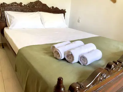a bed with a bunch of rolled towels on it at Kyparissos Apartment II in Kissamos