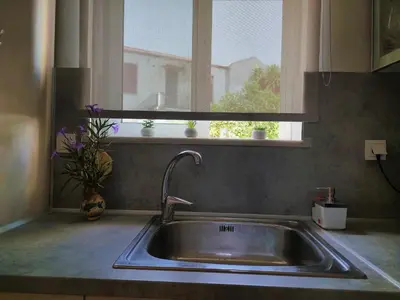 a sink in a kitchen with a window at Sunbeam Retreat in Chania Town