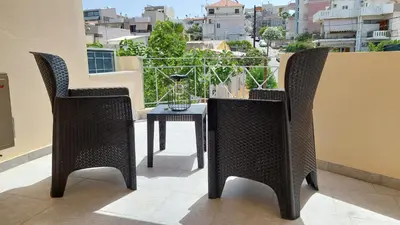 two chairs and a table on a balcony at Sunbeam Retreat in Chania Town
