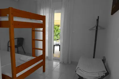 a bedroom with a bunk bed and a table at Sunbeam Retreat in Chania Town