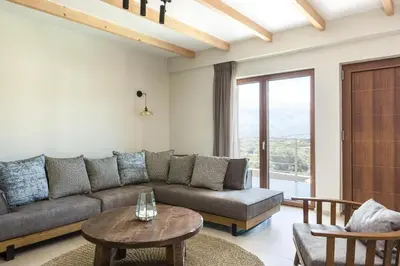 a living room with a couch and a table at Upper View Villa, with private pool in Chania Town