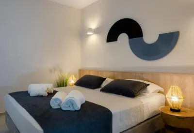 a bedroom with a large bed with towels on it at Upper View Villa, with private pool in Chania Town