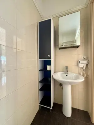 a bathroom with a sink and a mirror at Serenity house in Souda