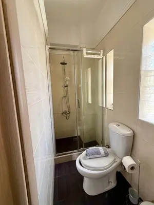 a bathroom with a toilet and a shower at Serenity house in Souda