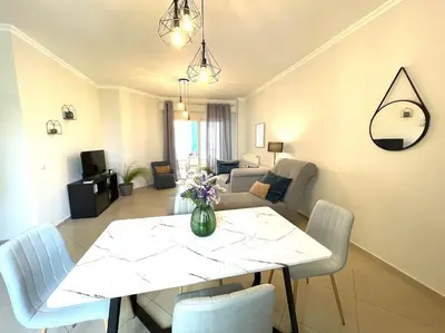 a living room with a white table and chairs at Thali central apartment with parking in Chania Town