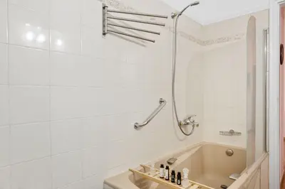 a white bathroom with a tub and a shower at Artistic Apartment in Chania in Chania Town