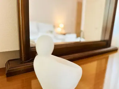 a white chair sitting in front of a mirror at Sea Breeze Sanctuary-1bd 3pl 1ba - 90m To Sea in Chania Town