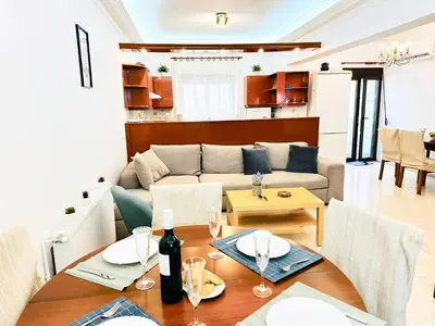 a living room with a couch and a table at Sea Breeze Sanctuary-1bd 3pl 1ba - 90m To Sea in Chania Town