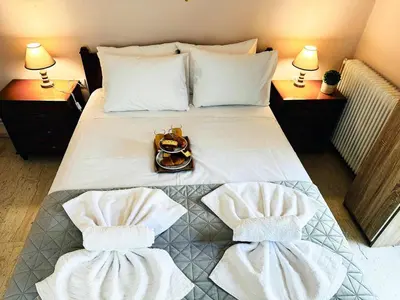 a hotel room with a bed with towels on it at Sea Breeze Sanctuary-1bd 3pl 1ba - 90m To Sea in Chania Town