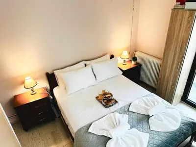 a small bedroom with a bed with two pillows at Sea Breeze Sanctuary-1bd 3pl 1ba - 90m To Sea in Chania Town