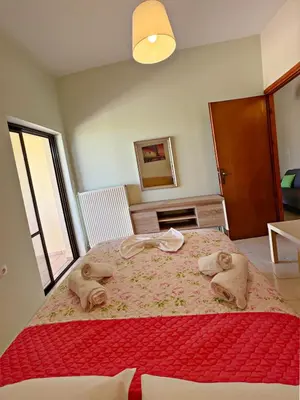a bedroom with a large bed with towels on it at Villa Marianna Lygides in Ayiá