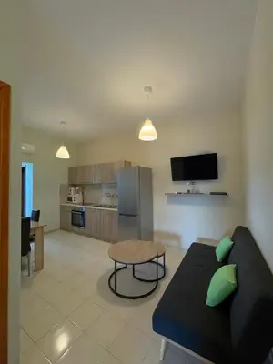 a living room with a couch and a table at Villa Marianna Lygides in Ayiá