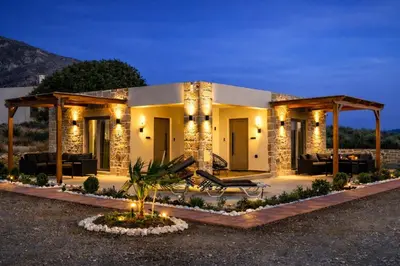 a house in the desert at night with lights at Holy Sea Smart Suites in Elafonisi