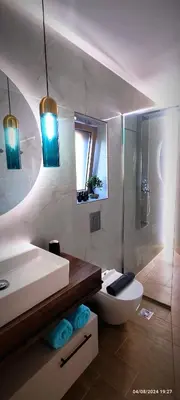 a bathroom with a sink and a toilet and a shower at Holy Sea Smart Suites in Elafonisi