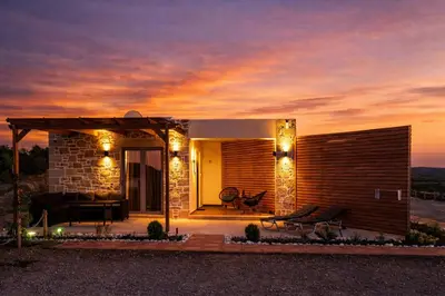 a house with a patio with lights on it at Holy Sea Smart Suites in Elafonisi